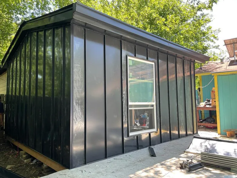 Black standing seam metal wall panels for Roof Inspection in Fulshear